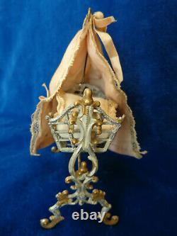 Antique dollhouse cradle with canopy and baby doll dated 1880