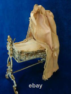 Antique dollhouse cradle with canopy and baby doll dated 1880