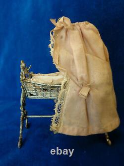 Antique dollhouse cradle with canopy and baby doll dated 1880