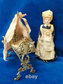 Antique dollhouse cradle with canopy and baby doll dated 1880