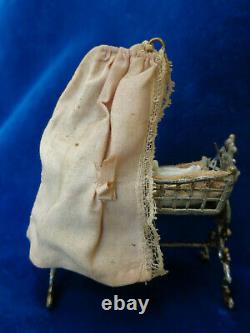 Antique dollhouse cradle with canopy and baby doll dated 1880