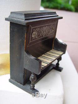 Antique dollhouse piano dated about 1900 made of wood