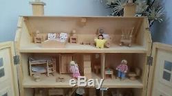 Classic four storey wooden dolls house with all furniture with people