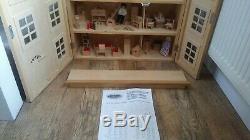 Classic four storey wooden dolls house with all furniture with people