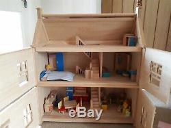 Large wooden Victorian dolls house, by Plan Toys