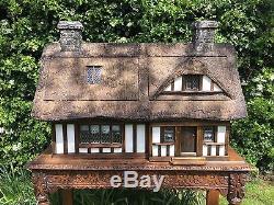 Stunning handmade, thatched country cottage dolls house